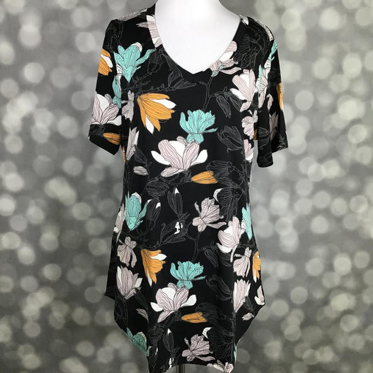 LuLaRoe Iris Tee in Midnight Magnolia featuring a black background with oversized ivory, aqua mint, blush, and golden floral blooms, rounded v-neckline, relaxed sleeves, and tunic-length silhouette.