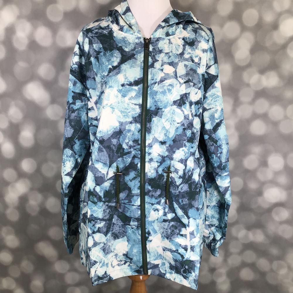 Floral patterned jacket on a mannequin against a blurred background