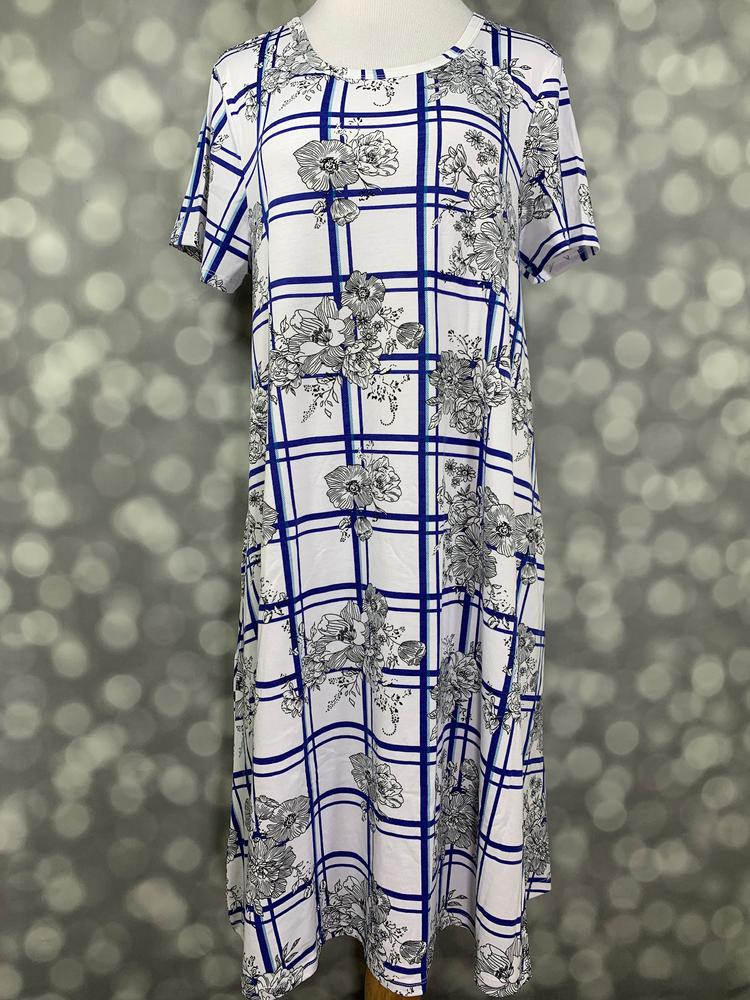 Front view of LuLaRoe Jessie dress on mannequin in white with blue plaid lattice and floral print, short sleeves, and flowy swing fit against a blurred background