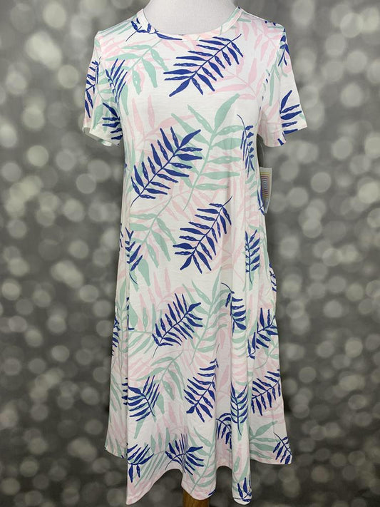 Front view of LuLaRoe Jessie dress on mannequin featuring white fabric with tropical palm leaf pattern in blue, mint green, and blush pink tones on a blurred background