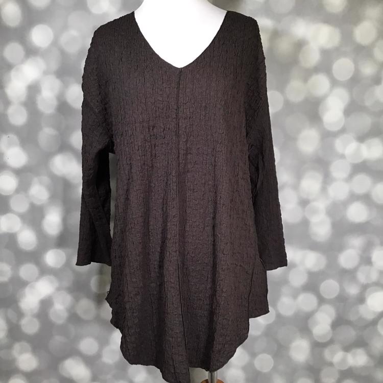 LuLaRoe Jolene V-neck tunic top in solid chocolate torte brown bubble jacquard fabric displayed on a mannequin. Long sleeve, relaxed-fit tunic with gauze-like texture and high-low hem.