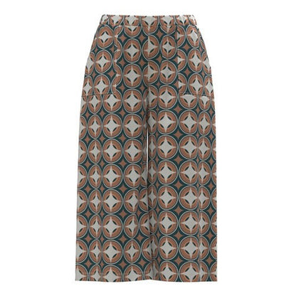 LuLaRoe Justine wide-leg pants with retro geometric medallion print in taupe, ivory, and teal tones, featuring elastic waistband and relaxed cropped fit on a white background