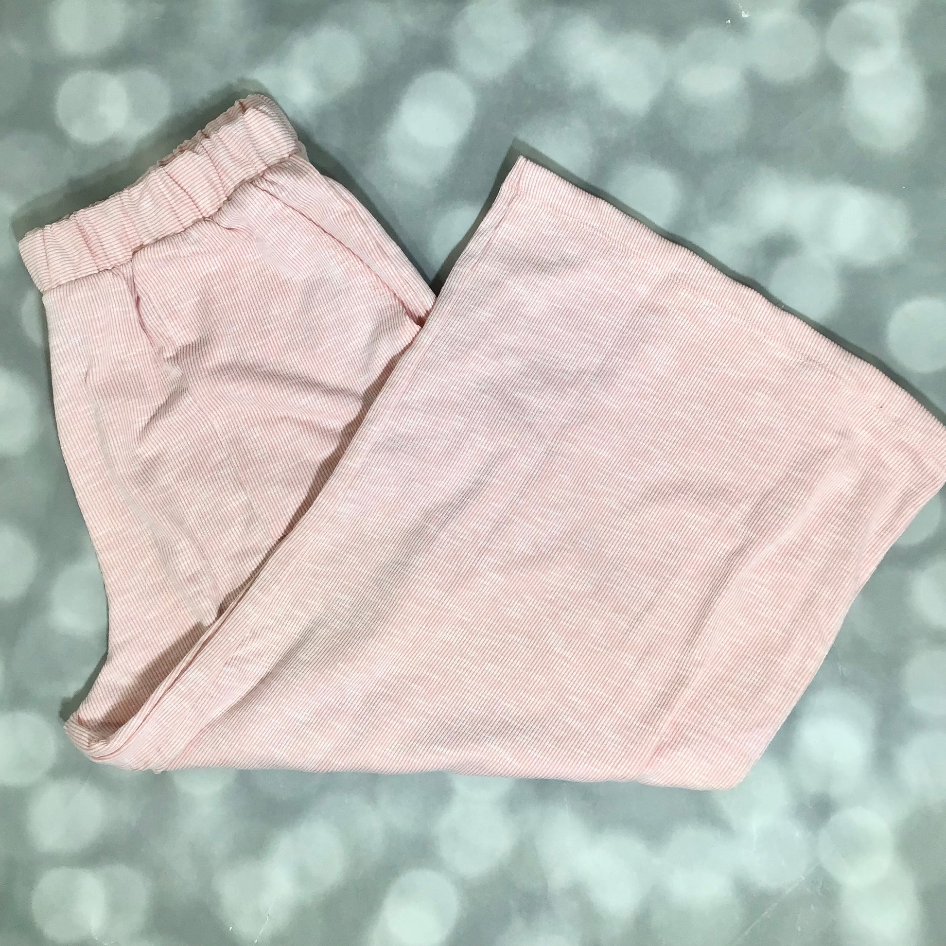 LuLaRoe Justine Pant in Solid Ballet Pink featuring a soft blush pink solid color, relaxed wide leg silhouette, elastic waistband, comfortable pull-on women's fashion pant.