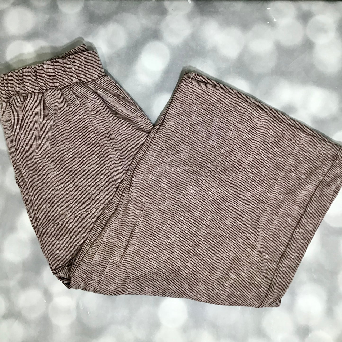 LuLaRoe Justine Pant in Solid Cocoa Truffle featuring a rich cocoa brown solid color, relaxed wide leg silhouette, elastic waistband, comfortable pull-on women’s fashion pant on a light gray background