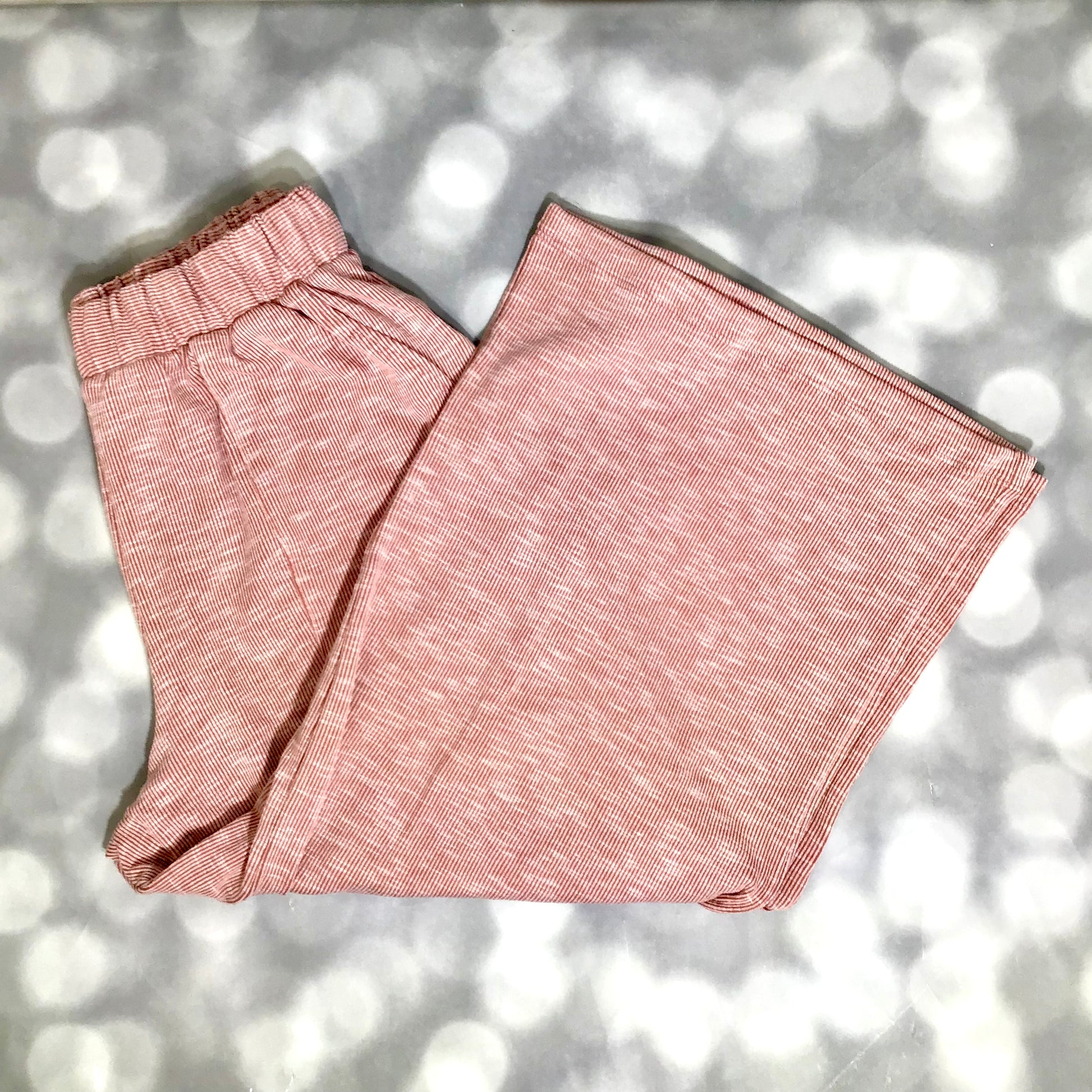 LuLaRoe Justine Pant in Solid Desert Rose featuring a warm dusty rose solid color with terracotta undertones, relaxed wide leg silhouette, elastic waistband, and comfortable pull-on styling.