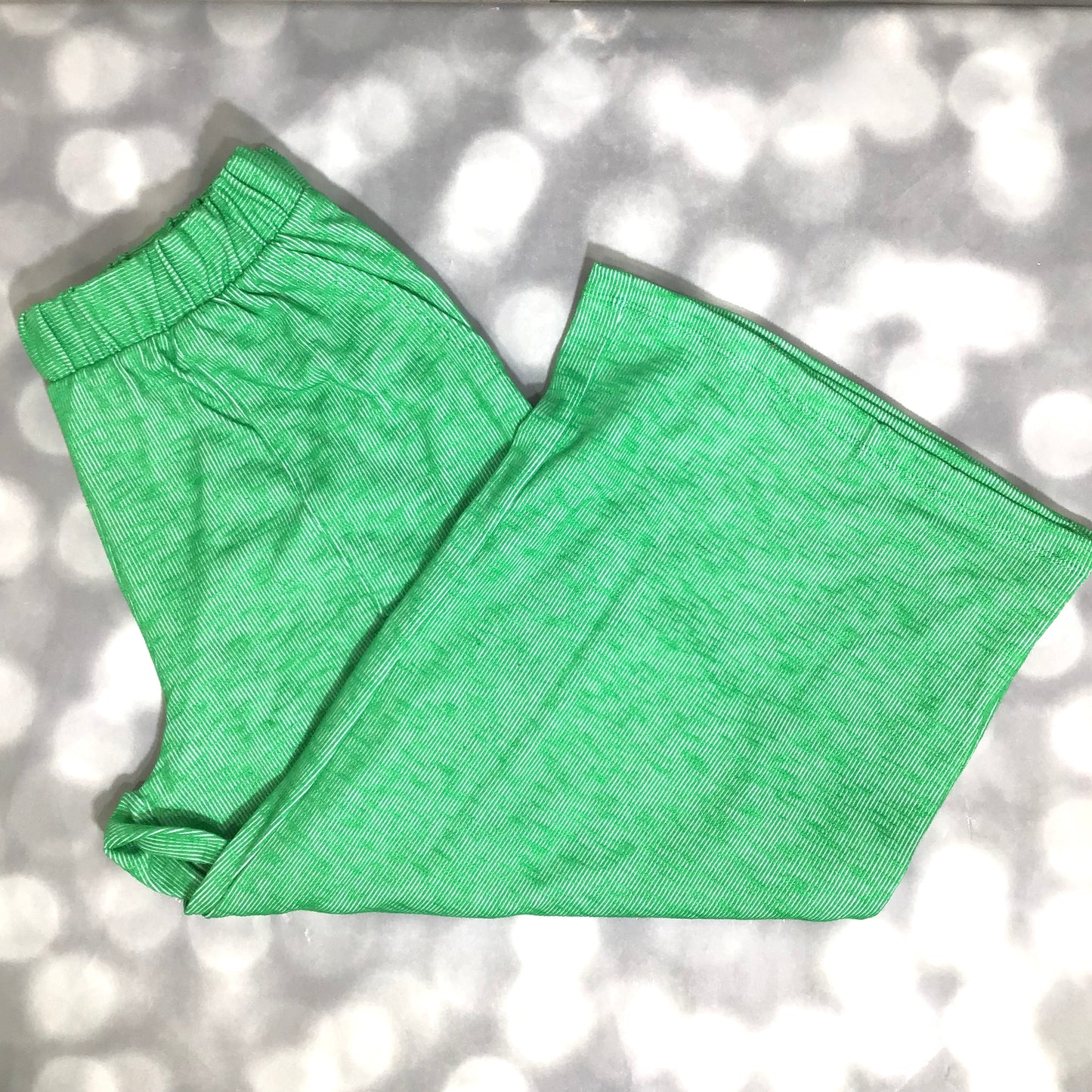 LuLaRoe Justine Pant in Solid Emerald Meadow featuring a vibrant emerald green solid color, relaxed wide leg silhouette, elastic waistband, and comfortable pull-on styling.