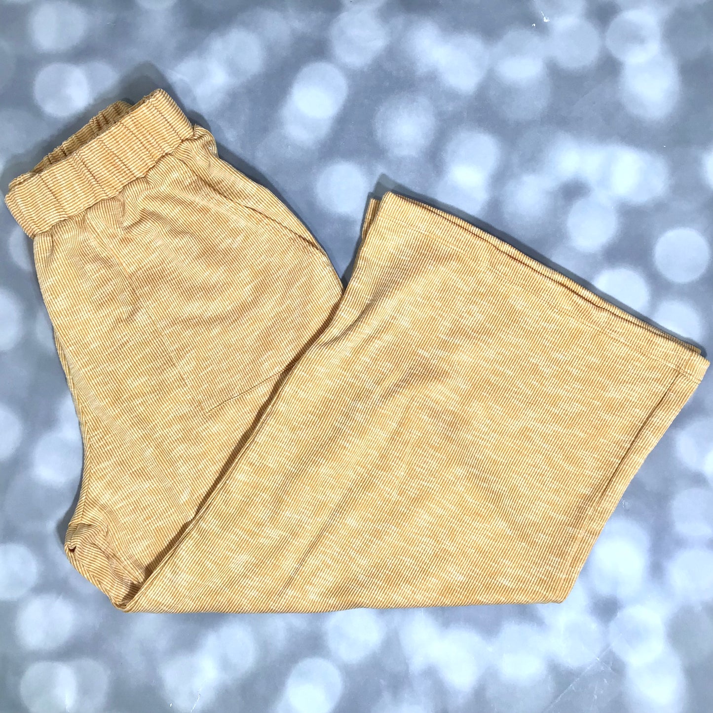 LuLaRoe Justine Pant in Solid Golden Honey featuring a warm golden yellow solid color, relaxed wide leg silhouette, elastic waistband, comfortable pull-on women's fashion pant.