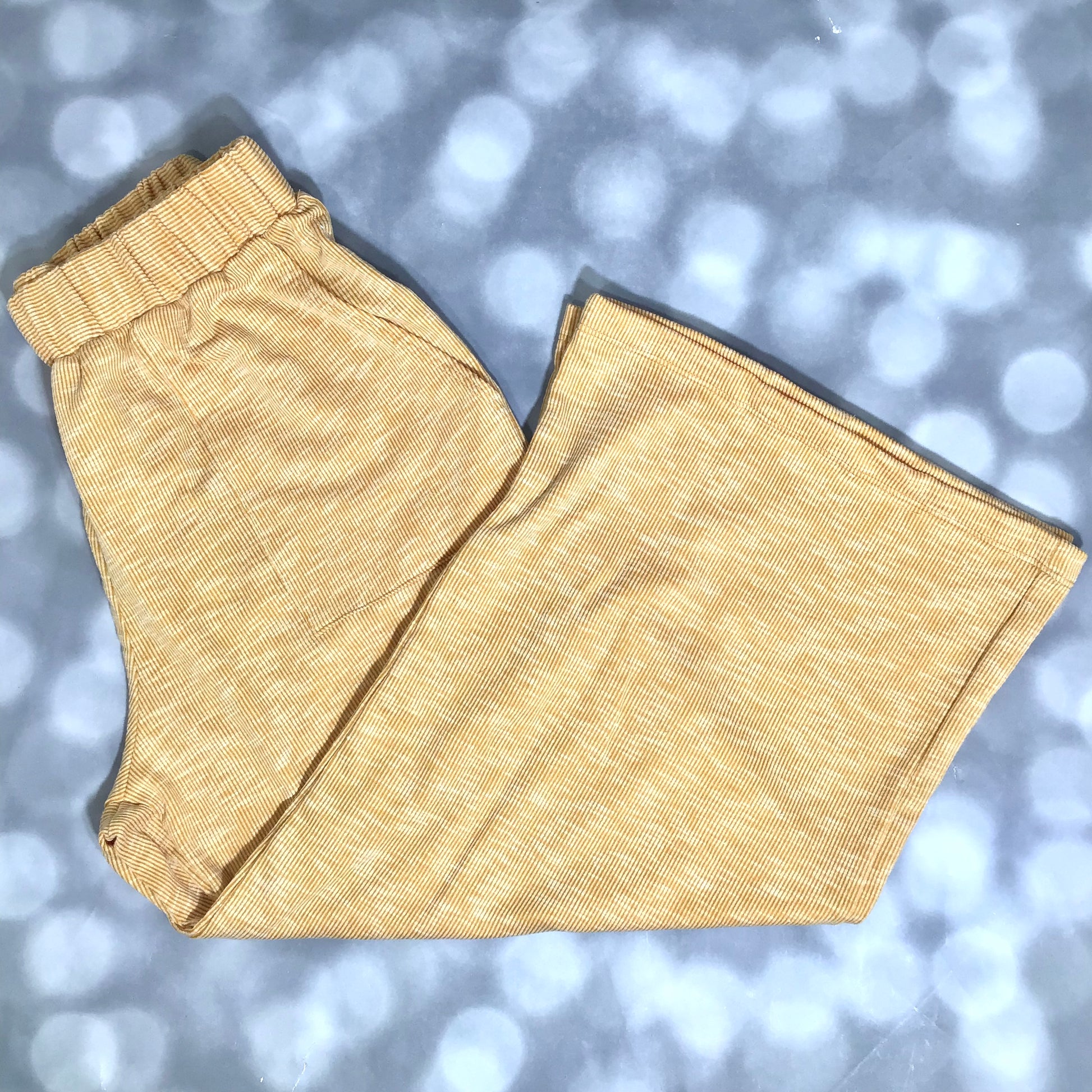 LuLaRoe Justine Pant in Solid Golden Honey featuring a warm golden yellow solid color, relaxed wide leg silhouette, elastic waistband, comfortable pull-on women's fashion pant.