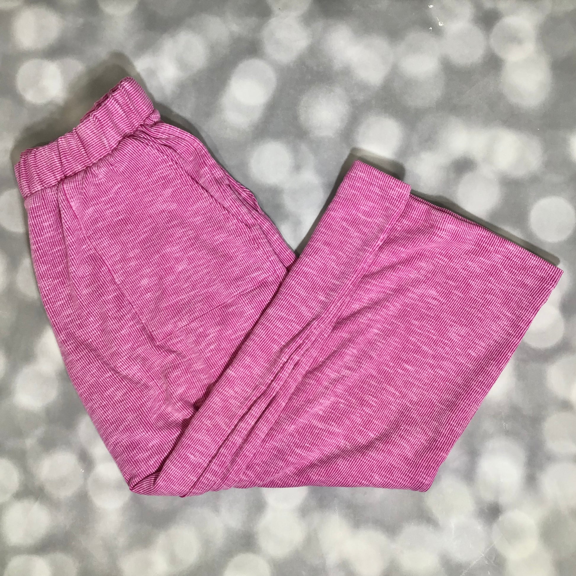 LuLaRoe Justine Pant in Solid Raspberry Orchid featuring a vibrant raspberry pink solid color, relaxed wide leg silhouette, elastic waistband, comfortable pull-on women’s fashion pant on a gray textured background