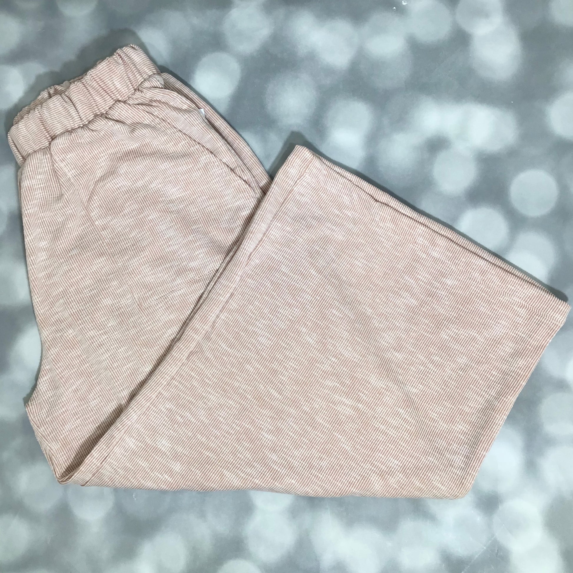LuLaRoe Justine Pant in Solid Sandstone Beige featuring a soft warm beige solid color, relaxed wide leg silhouette, elastic waistband, and comfortable pull-on styling for everyday wear.