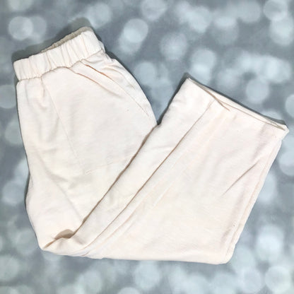 LuLaRoe Justine Pant in Solid Vanilla Cream featuring a soft ivory cream solid color, relaxed wide leg silhouette, elastic waistband, and comfortable pull-on styling.