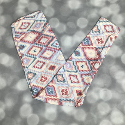 LuLaRoe leggings featuring a soft diamond-pattern print with a woven look in blush, teal, ivory, and denim blue tones, laid flat on a light gray background.