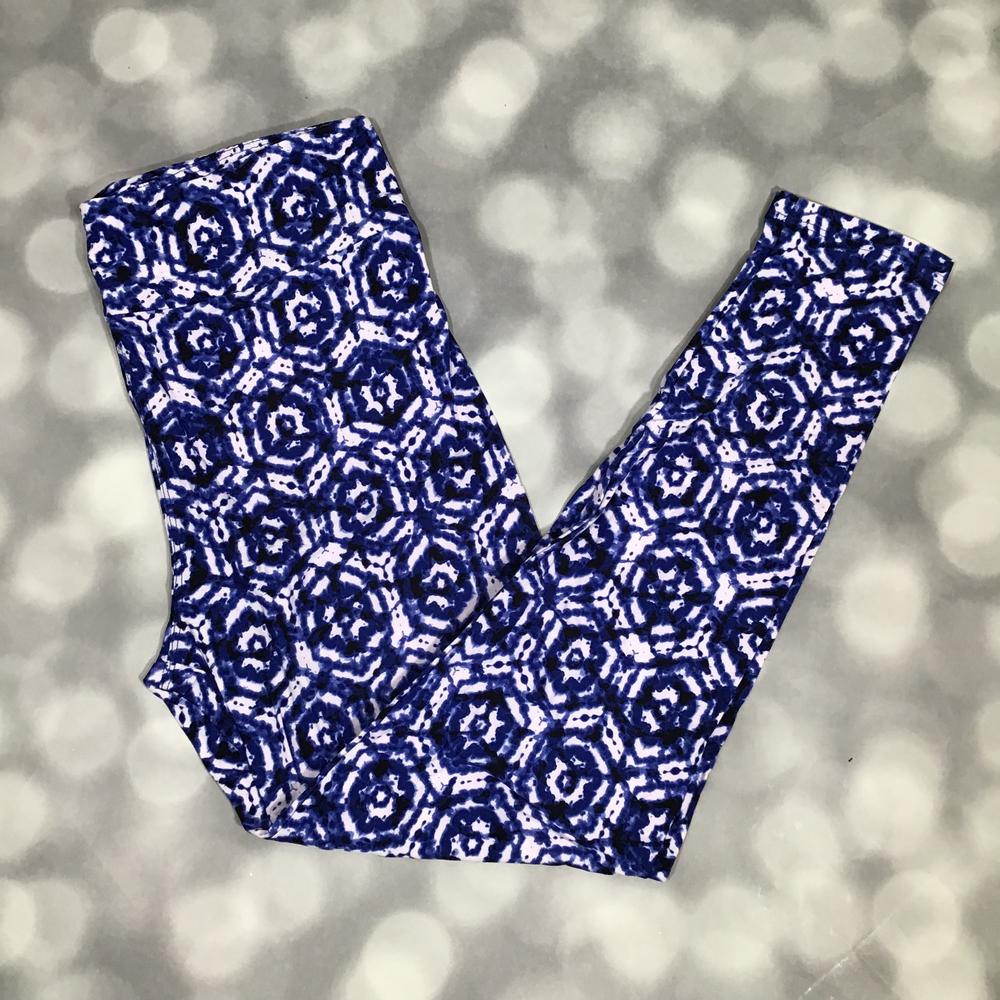 LuLaRoe leggings with indigo blue shibori-inspired geometric floral pattern on a white background, shown in flat lay on a gray background