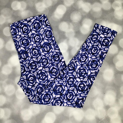 LuLaRoe leggings with indigo blue shibori-inspired geometric floral pattern on a white background, shown in flat lay on a gray background