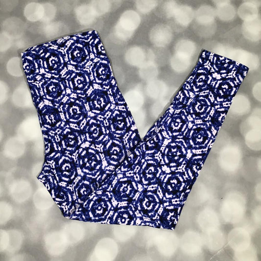 LuLaRoe leggings with indigo blue shibori-inspired geometric floral pattern on a white background, shown in flat lay on a gray background