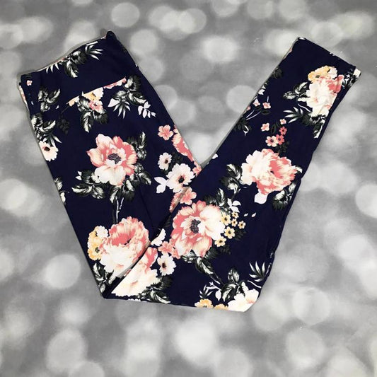 LuLaRoe leggings in navy with oversized pink, peach, and white florals accented by greenery