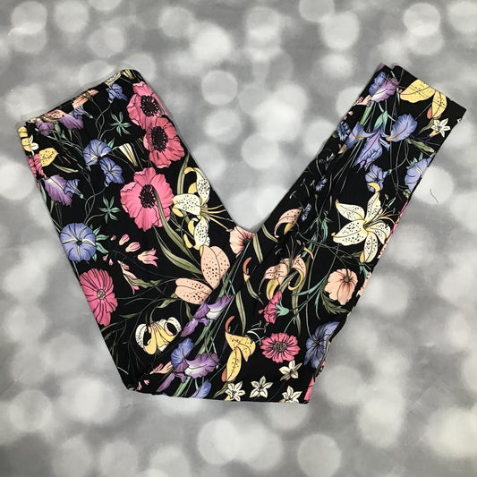 LuLaRoe black leggings with a midnight meadow botanical floral print featuring pink, purple, yellow, and green flowers on soft stretchy fabric
