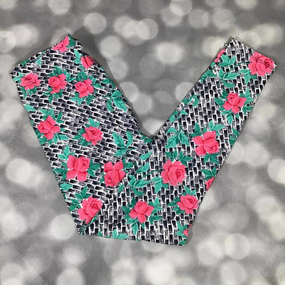 LuLaRoe leggings with neon pink roses and teal geometric grid on black background