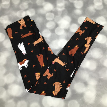 LuLaRoe leggings featuring a black background with illustrated dogs in neutral tones and small heart accents arranged in an all-over novelty pattern on a gray background