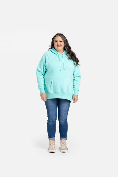Lexi Hooded Fleece Sweatshirt in solid teal aqua displayed on a model. Relaxed-fit hoodie with raglan sleeves, kangaroo pocket, ribbed cuffs and hem, and side slits.