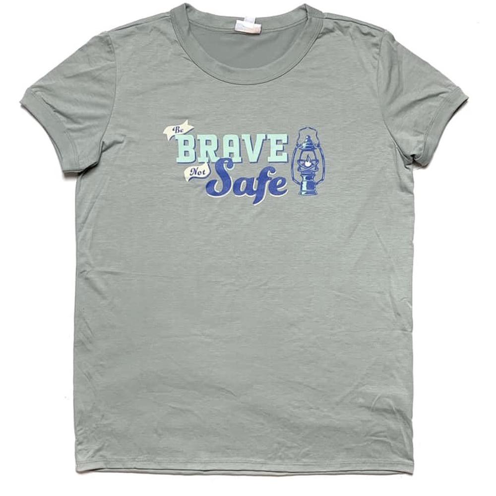 LuLaRoe Liv T in soft grey with ‘Be Brave Not Safe’ lantern graphic in blue” | “Front view of LuLaRoe Liv T on flat lay featuring inspirational ‘Be Brave Not Safe’ text and lantern print in blue tones on grey tee