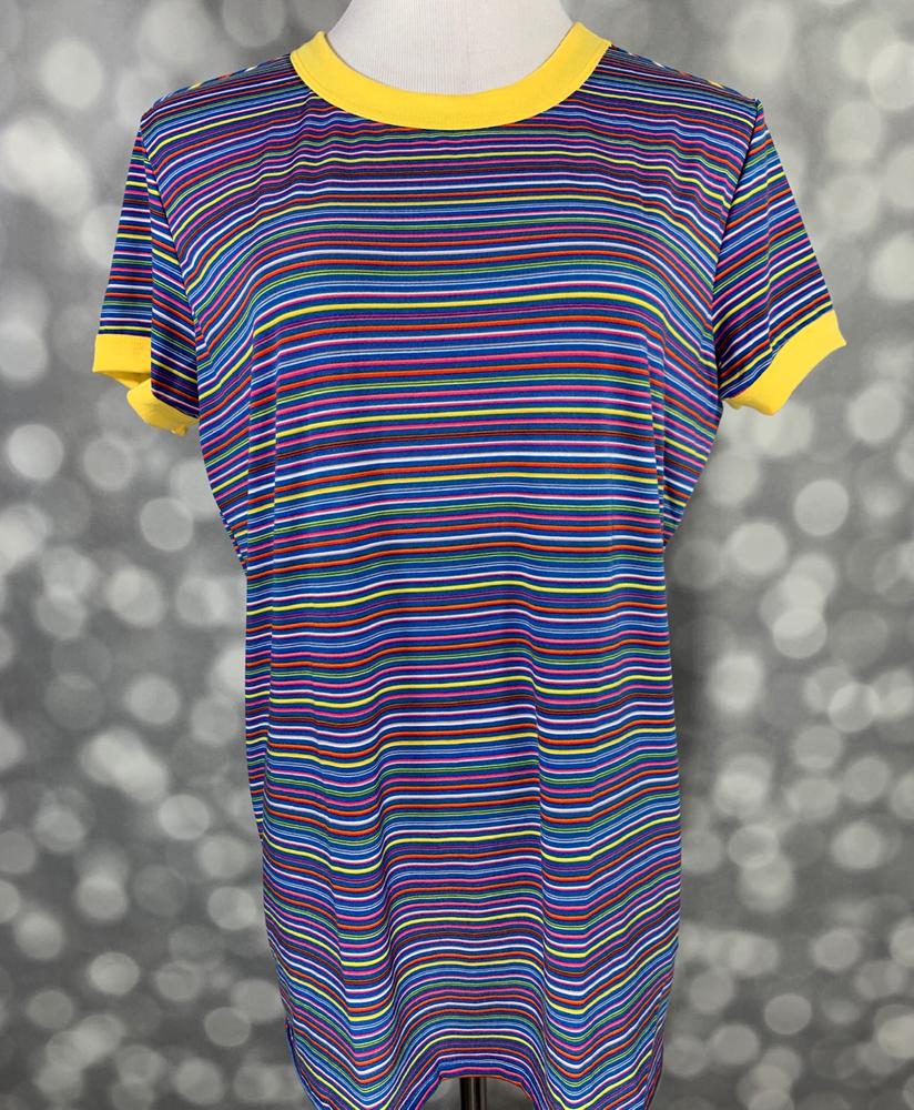 LuLaRoe Liv T in multicolor horizontal stripes with yellow contrast neckline and sleeve trim” | “Front view of LuLaRoe Liv T on mannequin featuring bright rainbow stripes with yellow collar and sleeve cuffs against a gray background.