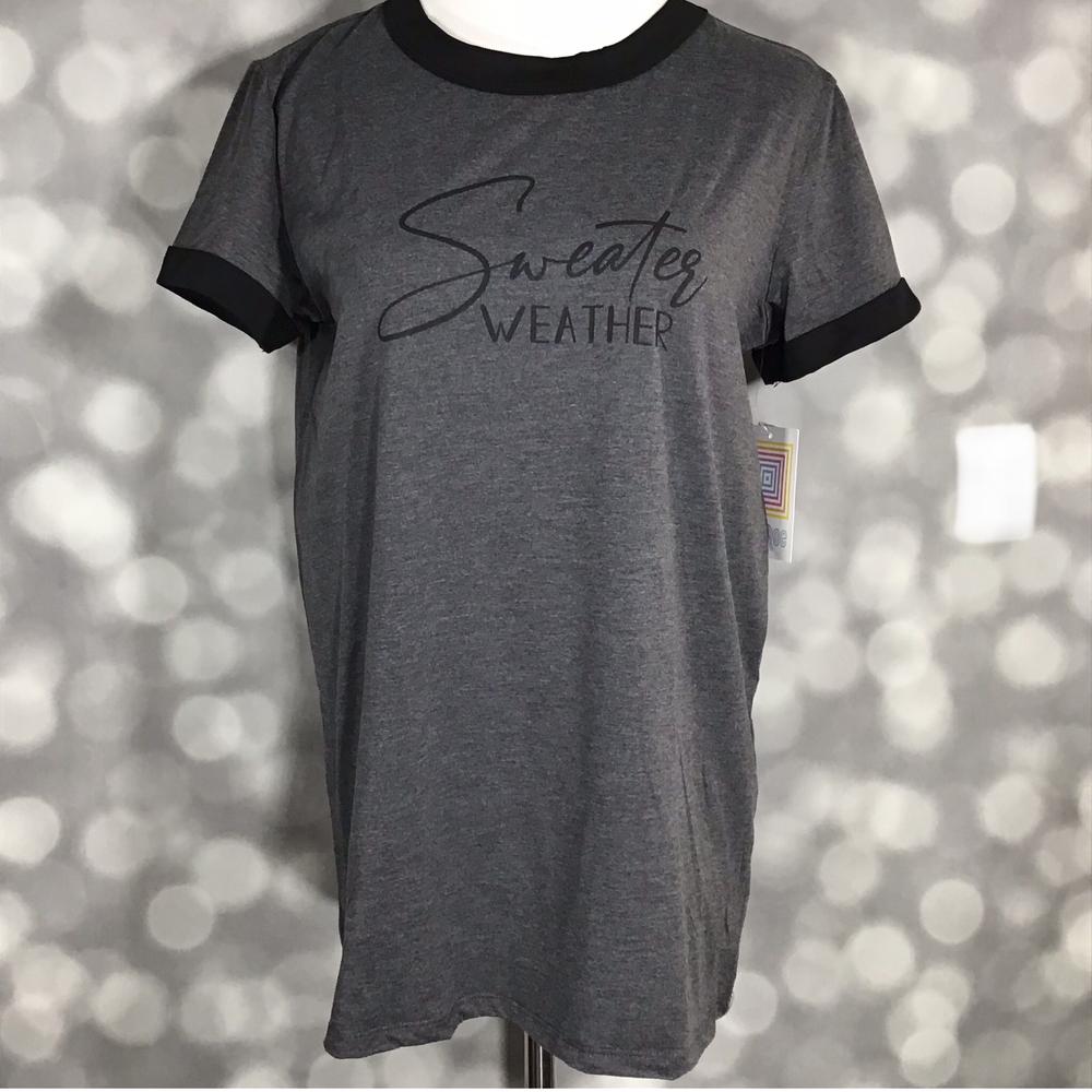 LuLaRoe Liv T in charcoal gray with black contrast trim and ‘Sweater Weather’ text graphic” | “Front view of LuLaRoe Liv T on mannequin featuring dark heather gray fabric, black neckline and sleeve trim, and minimalist ‘Sweater Weather’ lettering.