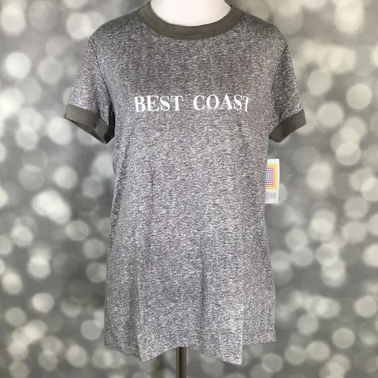 LuLaRoe Liv Tee in heather gray with olive trim and “Best Coast” graphic text, featuring short sleeves, relaxed fit, and curved hem displayed on a mannequin against a blurred background