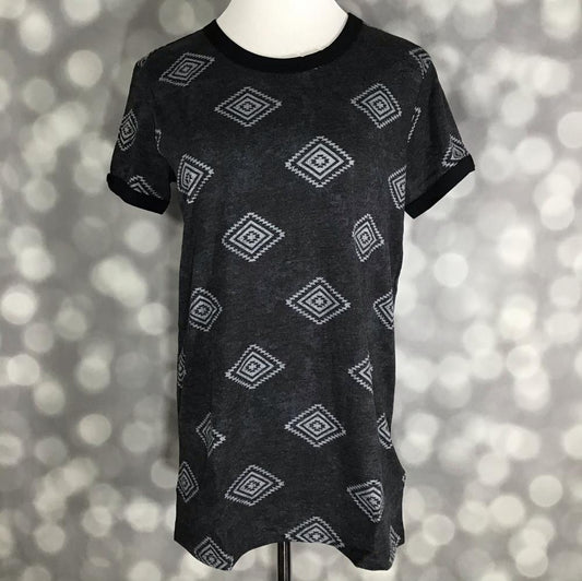 LuLaRoe Liv tee in charcoal gray with ivory diamond geometric print, featuring short sleeves, crew neckline, and relaxed fit, displayed on a mannequin against a blurred background