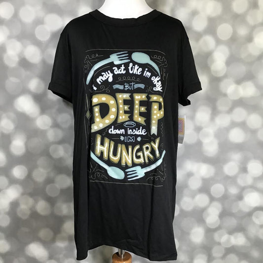 LuLaRoe Liv tee black graphic shirt with deep down I'm hungry food humor text and fork and spoon illustrations on a mannequin against a blurred background