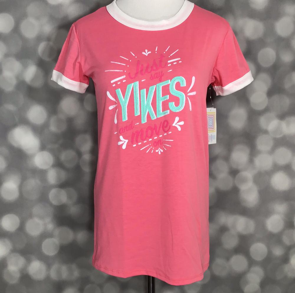 LuLaRoe Liv tee coral pink ringer shirt with just say yikes and move graphic texton a mannequin on a blurred gray background