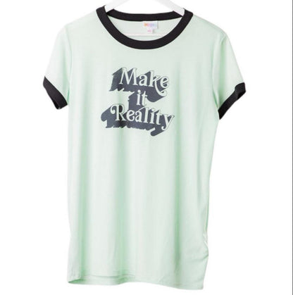 LuLaRoe Liv Tee in mint green with black trim and “Make It Reality” graphic text, featuring short sleeves, relaxed fit, and curved hem displayed on a hanger on a white background