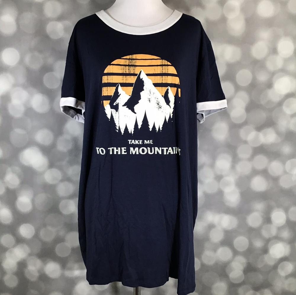 LuLaRoe Liv tee in navy with mountain sunset graphic and take me to the mountain text, short sleeves with white trim, relaxed fit casual top displayed on mannequin against a blurred background