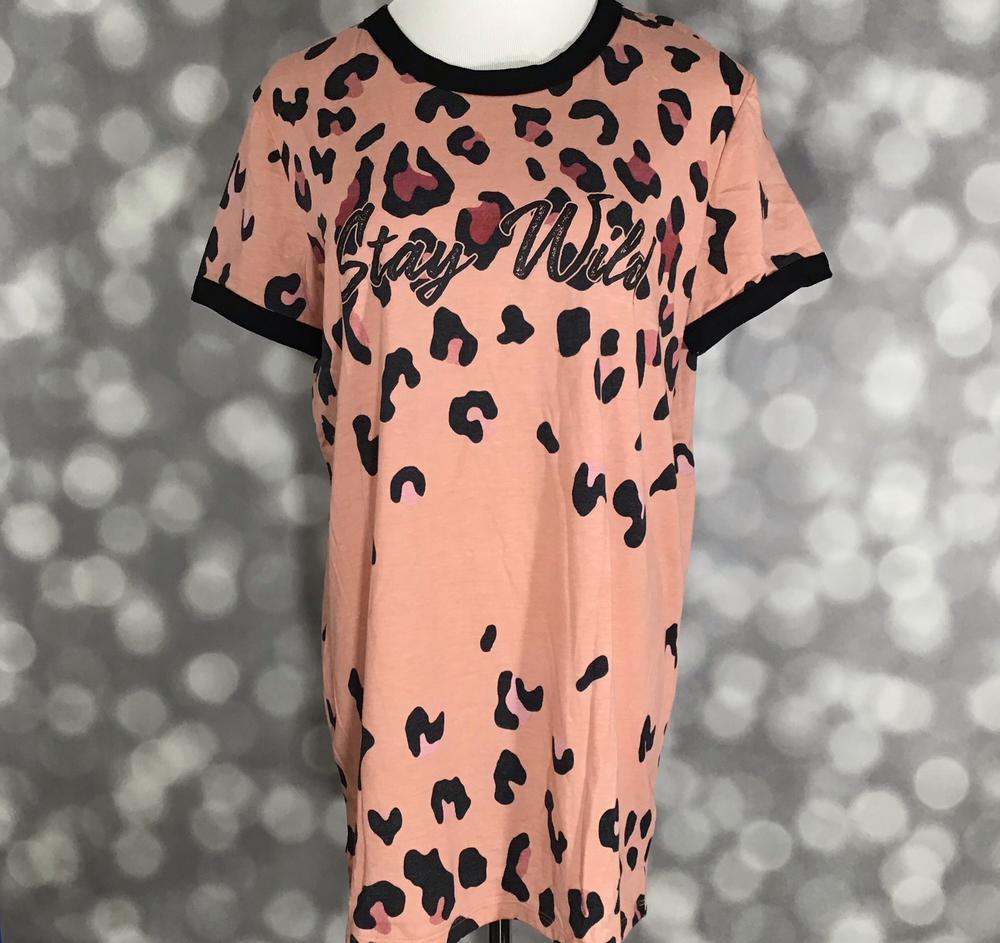 LuLaRoe Liv Tee peach shirt with black leopard print and stay wild graphic text on a blurred background