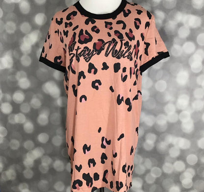 LuLaRoe Liv Tee peach shirt with black leopard print and stay wild graphic text on a blurred background