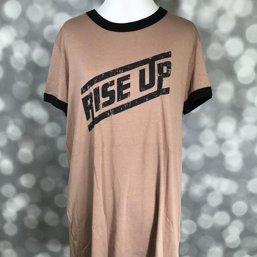 LuLaRoe Liv Tee tan shirt with 'RISE UP' graphic text and black trim on a blurred background