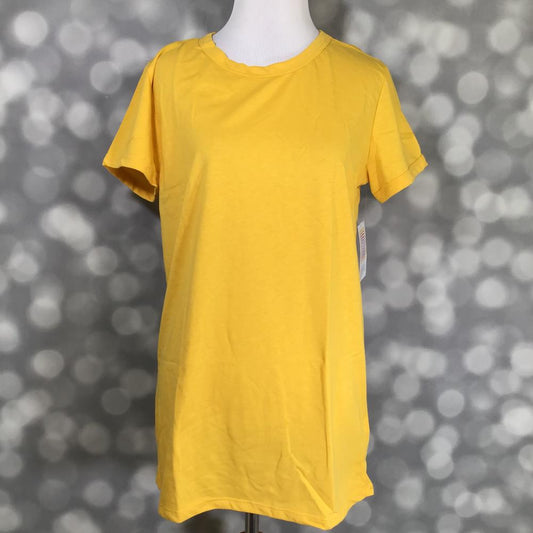 LuLaRoe Liv tee solid sunshine yellow relaxed fit short sleeve shirt on a mannequin with a blurred gray background