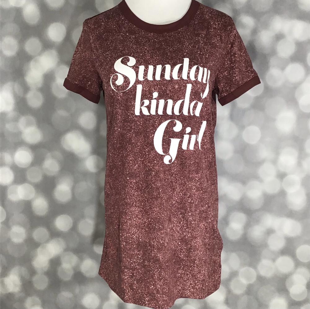 LuLaRoe Liv Tee rust brown shirt with "Sunday kinda girl"  graphic text on a blurred background