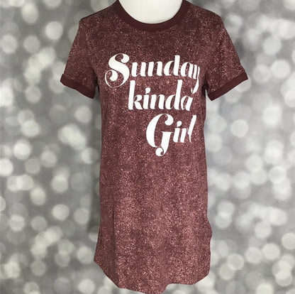 LuLaRoe Liv Tee rust brown shirt with "Sunday kinda girl"  graphic text on a blurred background