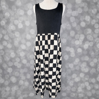 LuLaRoe Madeline Midi Tank Dress with a solid black tank bodice and black and ivory painterly checkerboard print midi skirt.