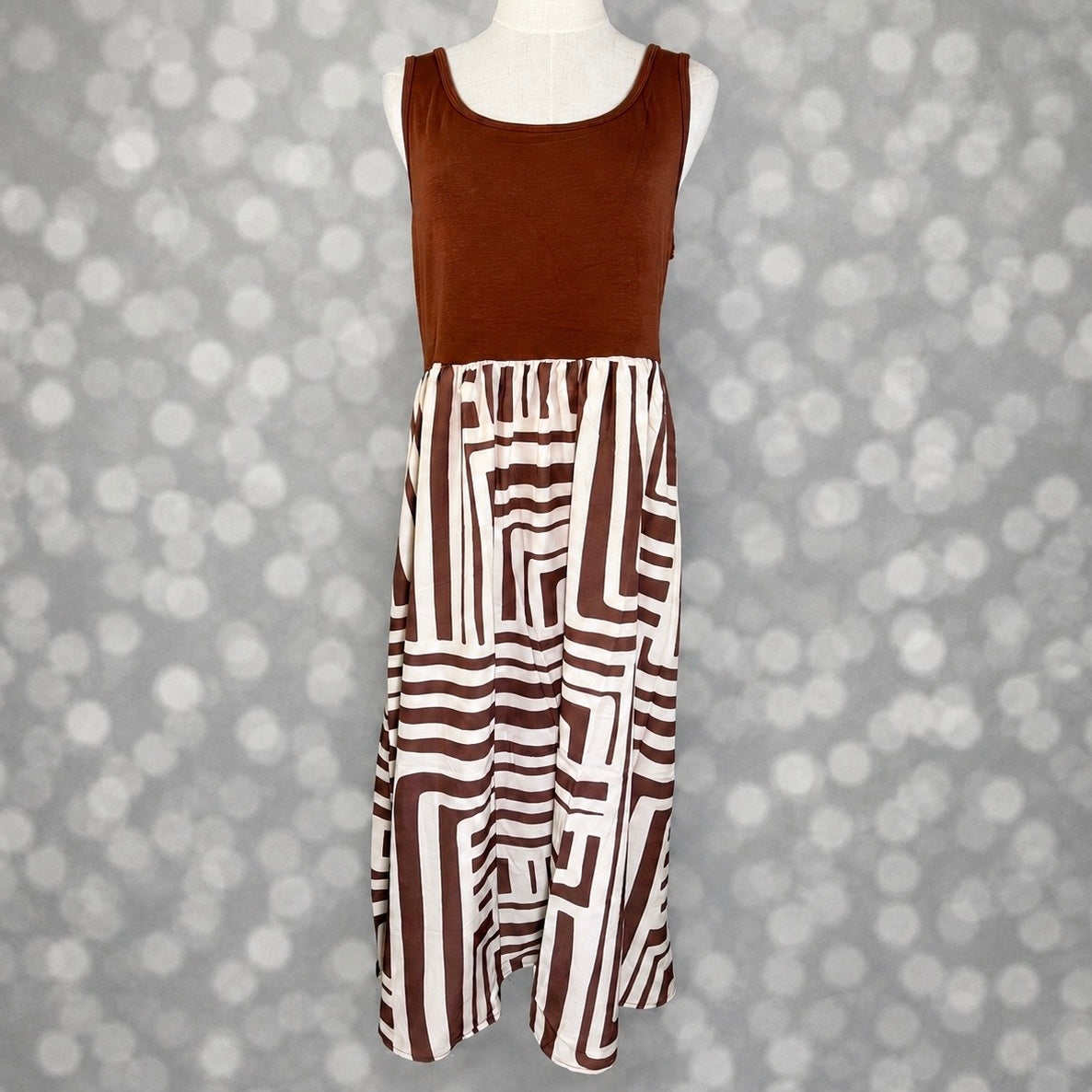 LuLaRoe Madeline Midi Tank Dress with a mocha brown tank bodice and ivory skirt featuring a bold mocha geometric maze print.