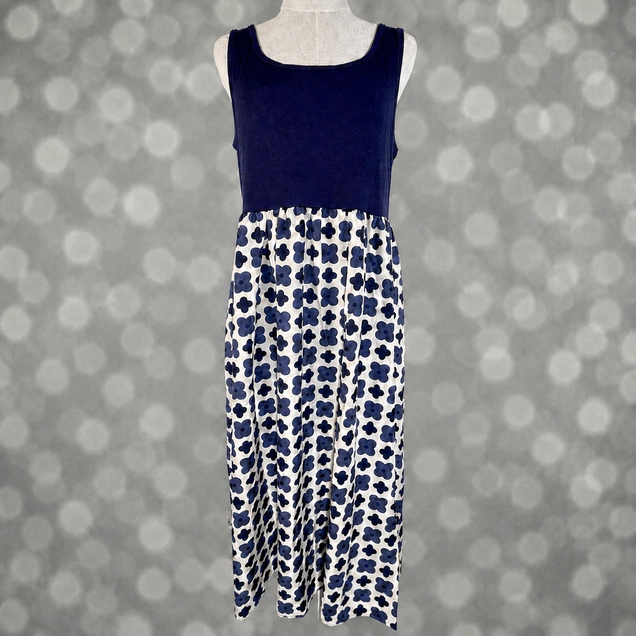 LuLaRoe Madeline Midi Tank Dress with a solid navy tank bodice and ivory skirt featuring a navy retro floral print.