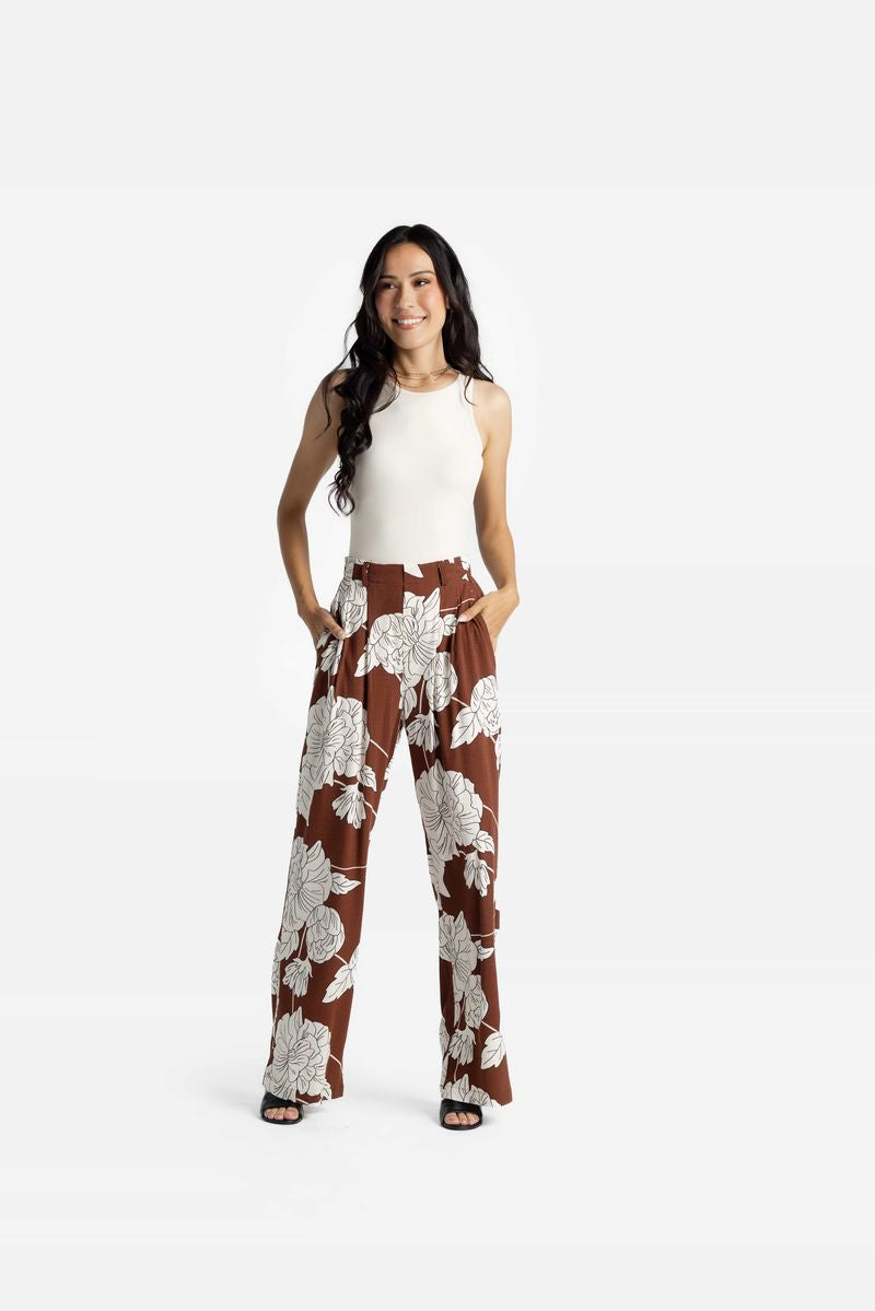 LuLaRoe Pamela Trouser in brown with large ivory floral print, wide leg flowy pants styled with neutral sleeveless top on a white background