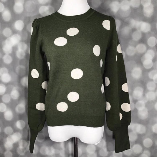 LuLaRoe Piper Sweater in deep evergreen knit with oversized ivory polka dots, balloon sleeves, ribbed neckline and extended rib cuffs displayed on mannequin against gray backdrop.