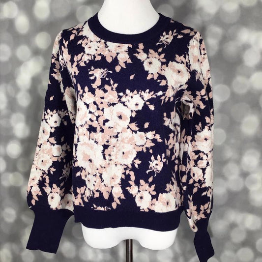 LuLaRoe Piper Sweater in deep navy knit with blush and ivory floral print, solid navy ribbed neckline, hem, and extended cuffs, featuring balloon sleeves displayed on mannequin against gray background.