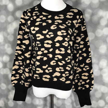 LuLaRoe Piper Sweater in black and tan leopard print with balloon sleeves, ribbed neckline, extended rib cuffs, and ribbed hem displayed on mannequin against soft gray background.