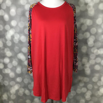LuLaRoe Randy raglan tee featuring solid scarlet red body with long multicolor floral raglan sleeves in mustard, burgundy, blush, and white displayed on a mannequin against a blurred background