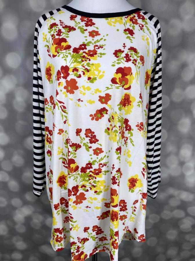 LuLaRoe Randy Tee with ivory floral print in yellow and red tones and black and white striped long sleeves on a mannequin