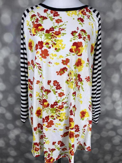LuLaRoe Randy Tee with ivory floral print in yellow and red tones and black and white striped long sleeves on a mannequin