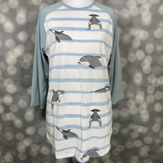 LuLaRoe Randy Tee with whale print, light blue stripes, and seafoam green long sleeves on a mannequin against a blurred background